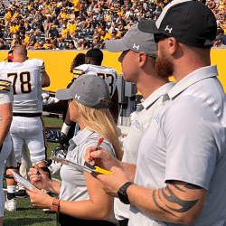 Strength coaches on the sideline during a game